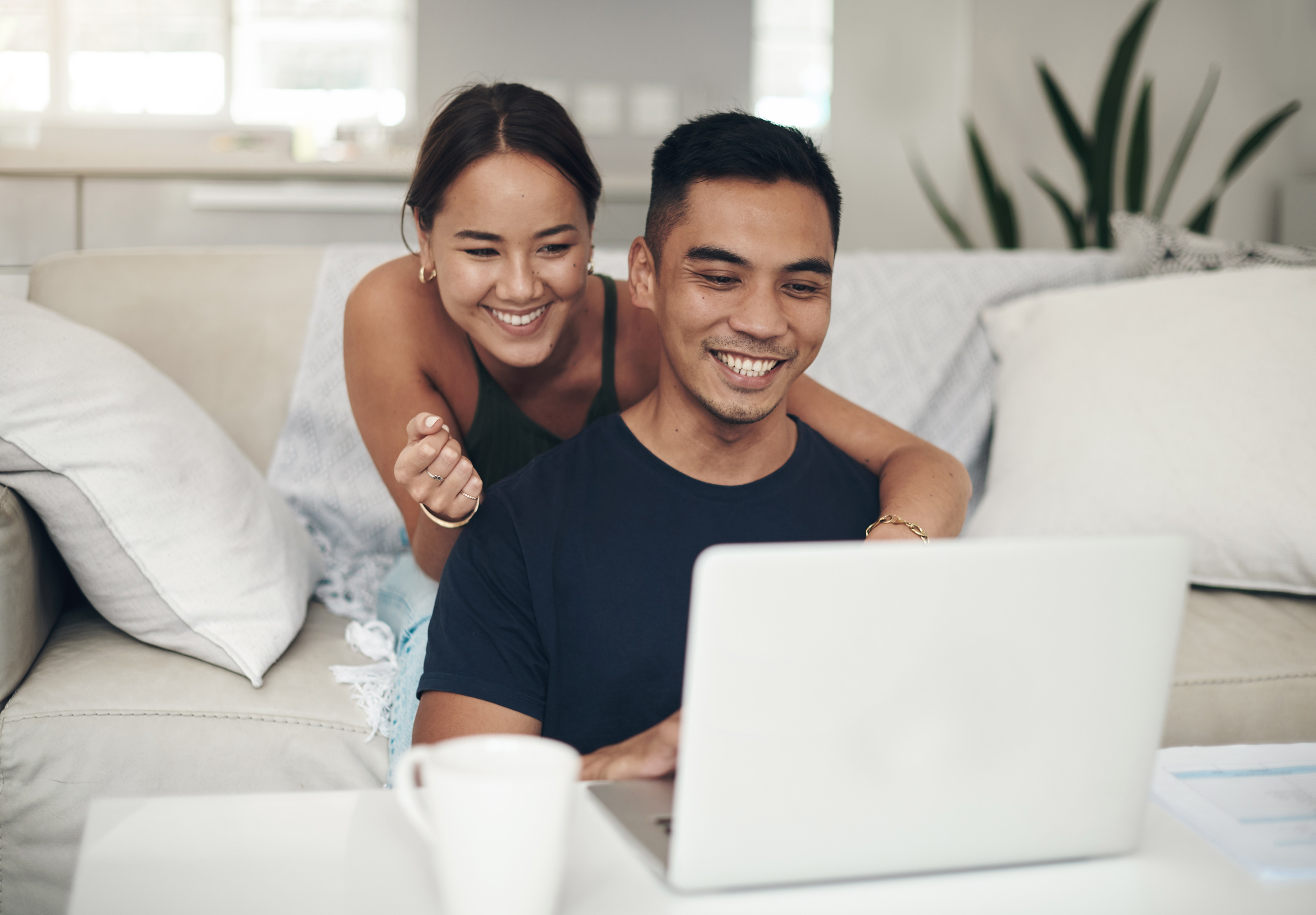 Smiling Couple Relaxing Indoors With A Laptop 2026 01 09 11 15 08 Utc