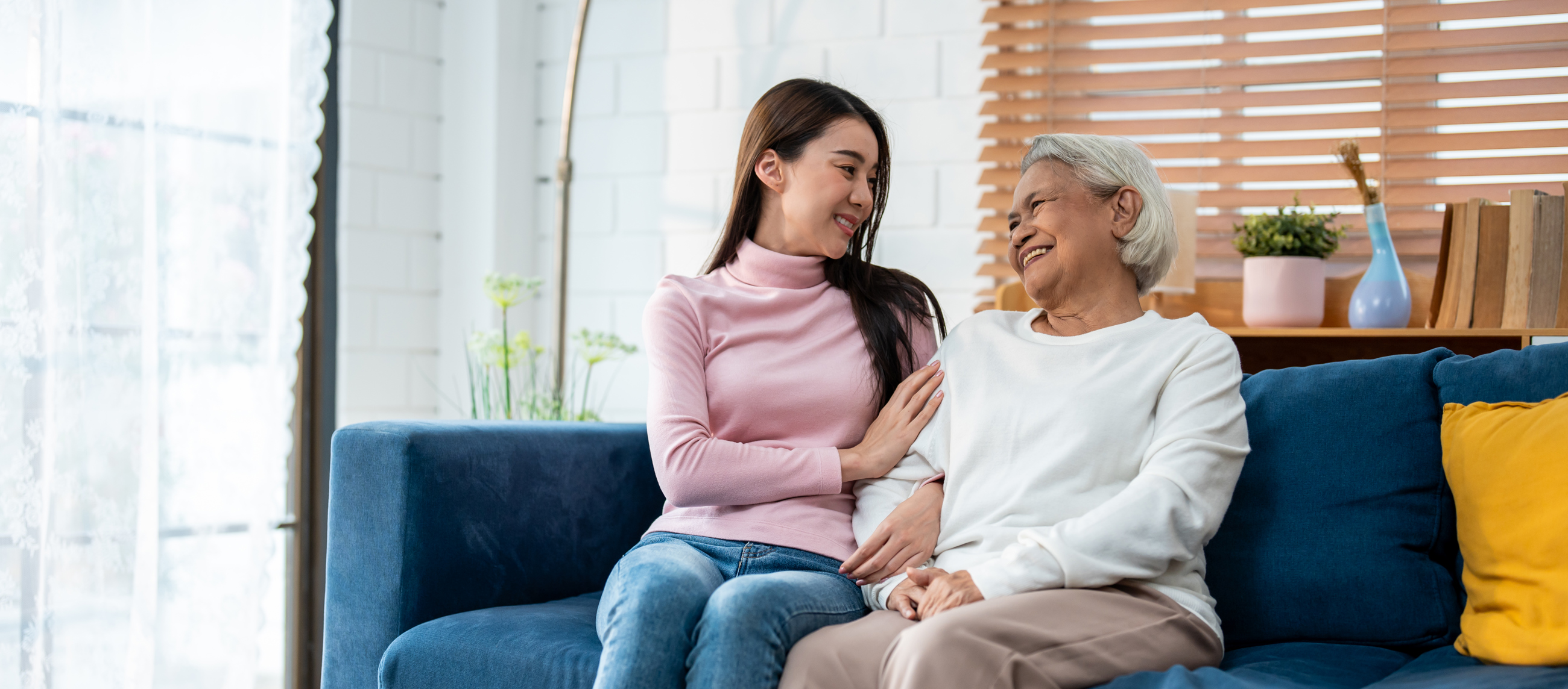 Woman And Senior Woman Sitting On Couch Smiling 2026 01 09 07 40 55 Utc